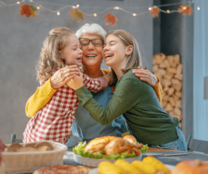 Grandmother cooking holiday meal with her granddaughters