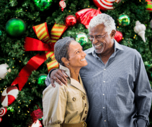 Couple in fron of holiday Christmas tree