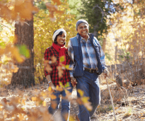 Couple walking in the woods during autumn