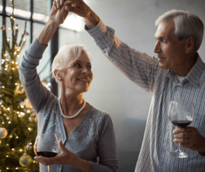Couple dancing in front of Christmas tree