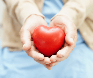 Hands holding a heart shaped object