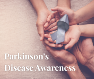 Parkinson's Awareness Month, hands holding a purple ribbon